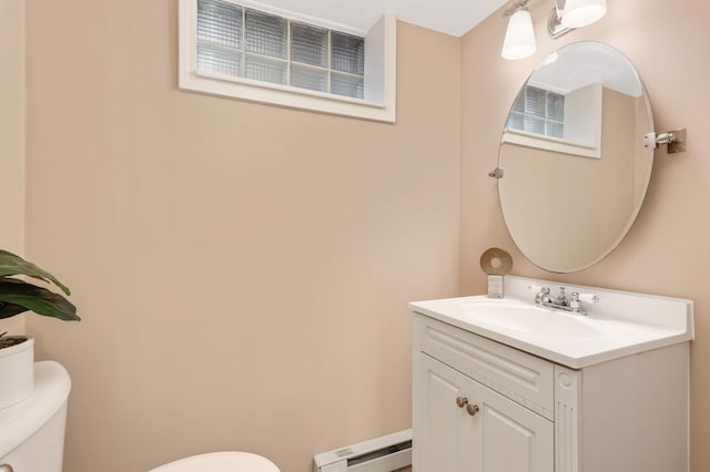 bathroom with toilet, baseboard heating, and vanity