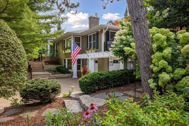 view of front of property with a chimney and stairway