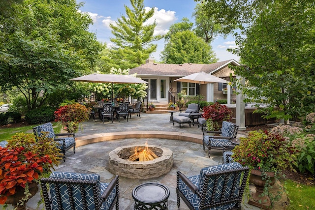 view of patio / terrace with a fire pit and entry steps