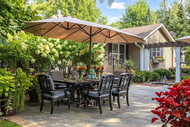 view of patio featuring a pergola and outdoor dining space