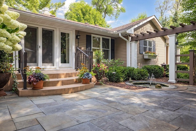 entrance to property featuring a patio