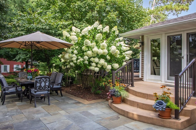 view of patio / terrace featuring outdoor dining space and stairway