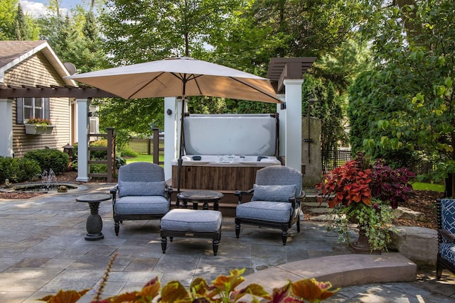 view of patio featuring fence, a pergola, and a hot tub