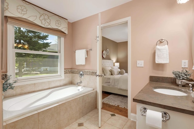 17001 The Strand, Minnetonka, MN 55345 - ensuite bathroom with tile patterned floors, a bath, and vanity