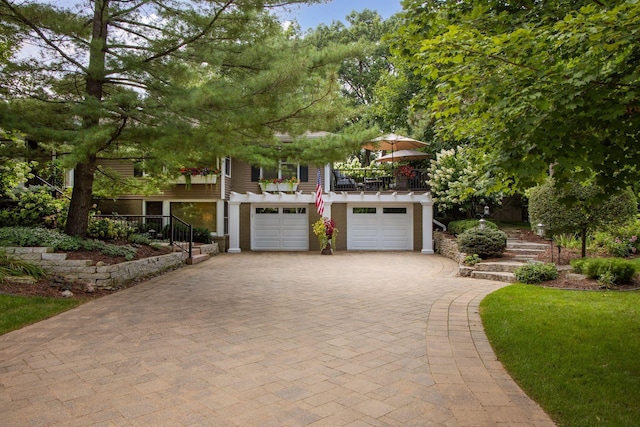 17001 The Strand, Minnetonka, MN 55345 - obstructed view of property with a garage, decorative driveway, stairs, and a balcony