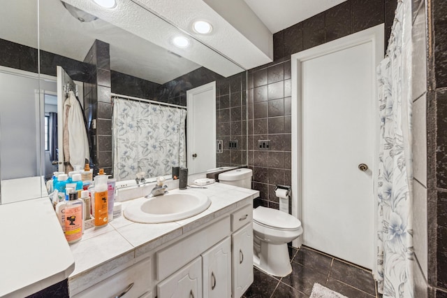 bathroom with tile walls, tile patterned floors, vanity, toilet, and a shower with shower curtain