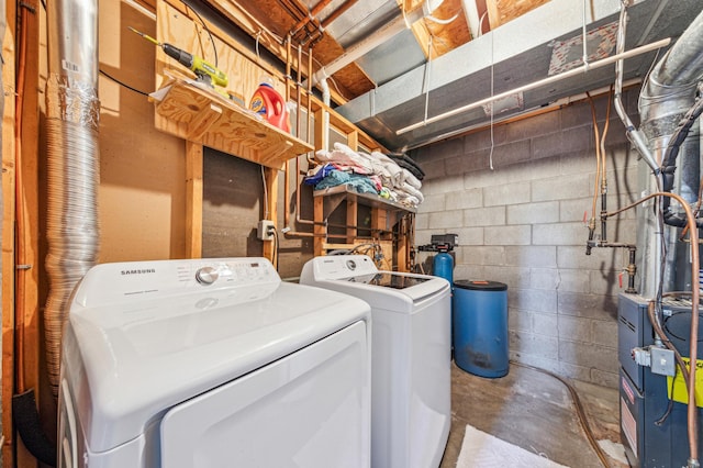washroom featuring laundry area, independent washer and dryer, and concrete block wall