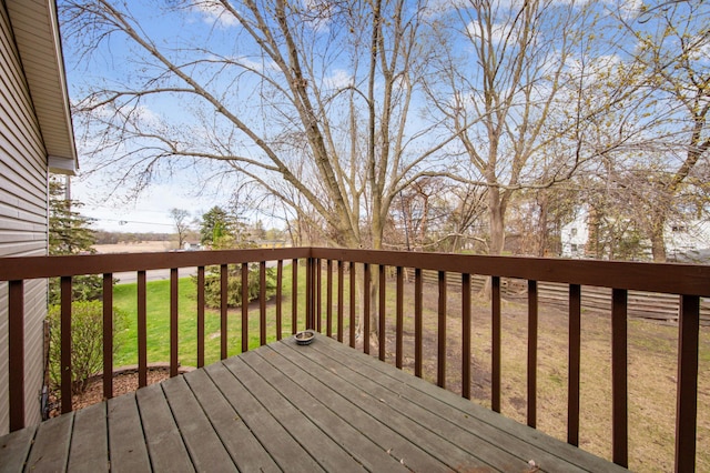 wooden terrace featuring a yard
