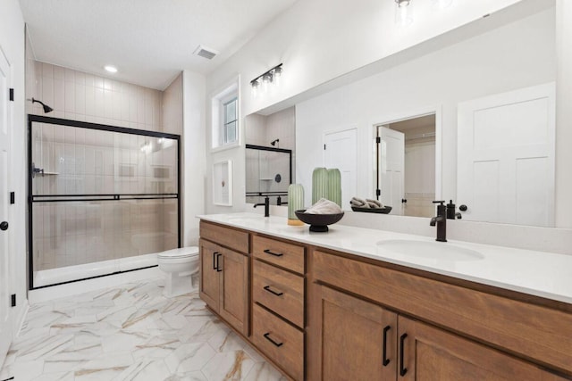 full bath with visible vents, double vanity, marble finish floor, a sink, and a stall shower