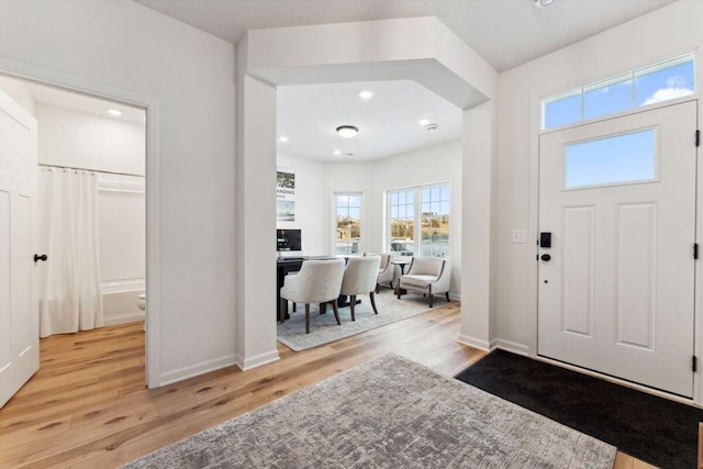foyer featuring recessed lighting, baseboards, and light wood-type flooring