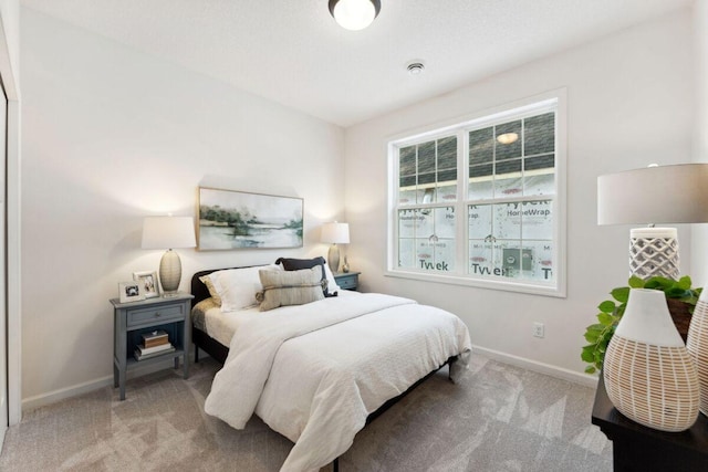 carpeted bedroom featuring baseboards