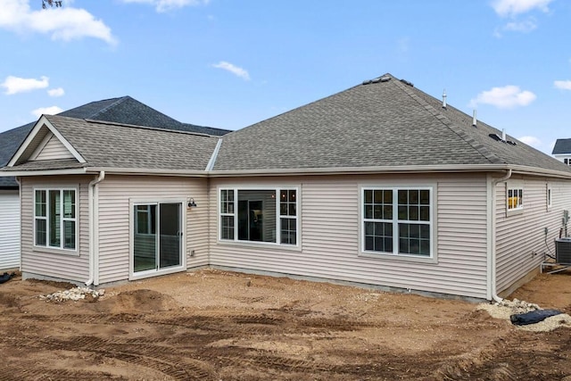 rear view of house with roof with shingles