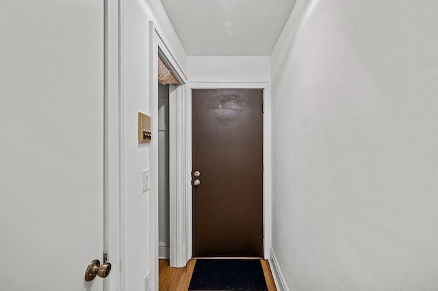 entryway featuring baseboards and light wood finished floors