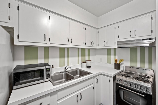 kitchen featuring white cabinets, appliances with stainless steel finishes, a sink, light countertops, and under cabinet range hood