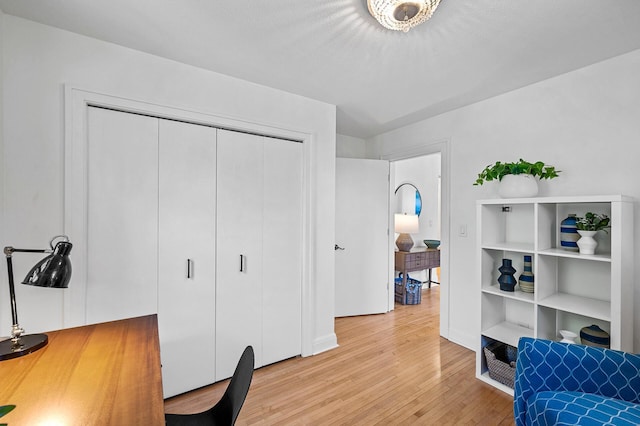home office with baseboards and light wood-style flooring