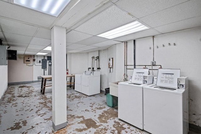 laundry area featuring independent washer and dryer, laundry area, and a sink