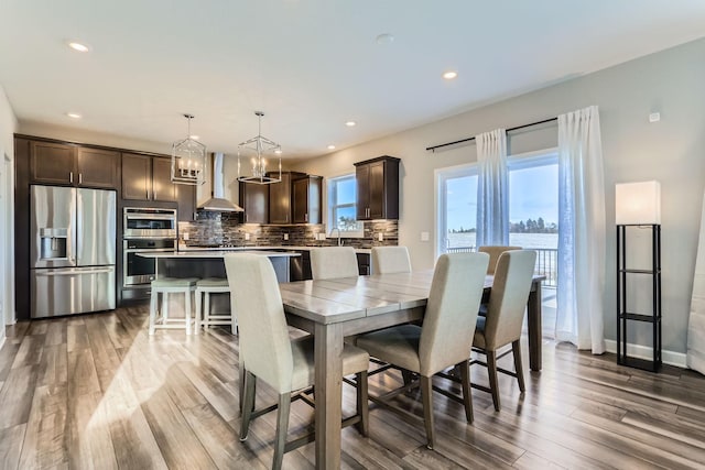 dining space featuring recessed lighting, baseboards, and light wood-type flooring