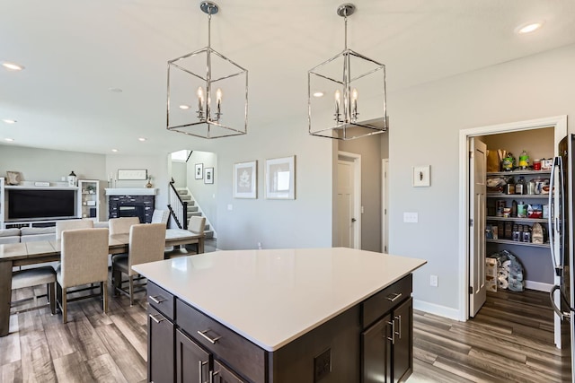 kitchen with hanging light fixtures, an inviting chandelier, and wood finished floors