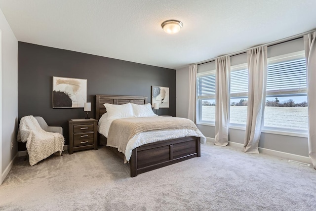 bedroom featuring carpet floors and baseboards
