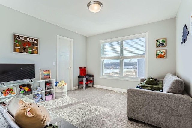 recreation room featuring baseboards, carpet flooring, and visible vents