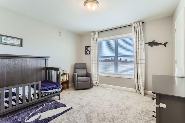 bedroom featuring carpet flooring, baseboards, and a crib