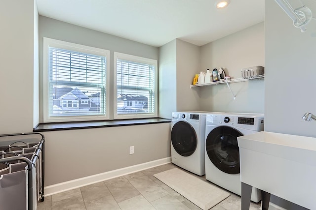 washroom with laundry area, baseboards, recessed lighting, washer and clothes dryer, and a sink
