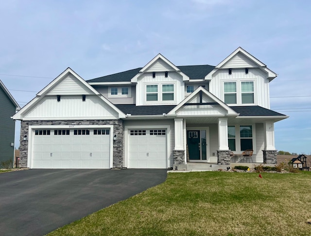 craftsman-style house with board and batten siding, driveway, and stone siding