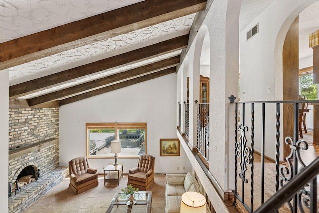 carpeted living room featuring arched walkways and a brick fireplace