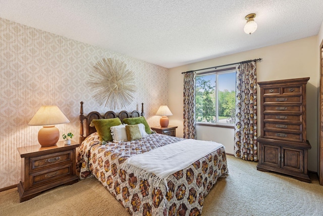 carpeted bedroom with wallpapered walls, a textured ceiling, and baseboards