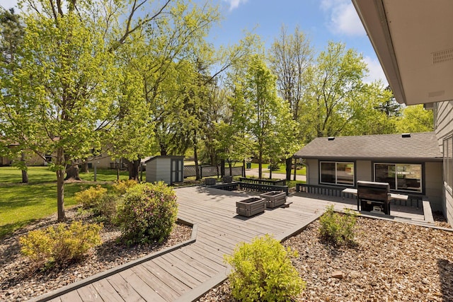 deck featuring a storage unit, an outbuilding, and a lawn