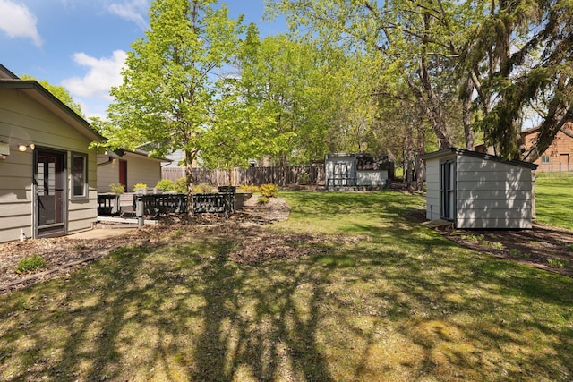 view of yard with a storage shed and an outbuilding
