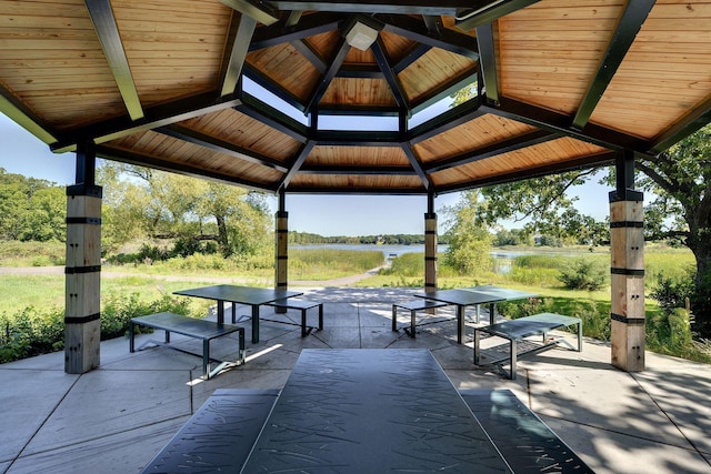 view of community featuring a gazebo, a water view, and a patio