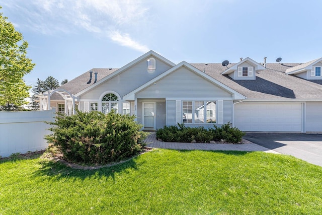 267 Plum Run, Le Sueur, MN 56058 - view of front of property featuring fence, driveway, a front yard, and a garage
