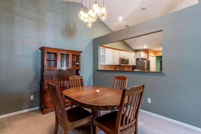 267 Plum Run, Le Sueur, MN 56058 - dining room featuring baseboards, lofted ceiling, a notable chandelier, and light carpet