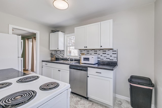 kitchen with white appliances, a sink, backsplash, dark countertops, and white cabinets