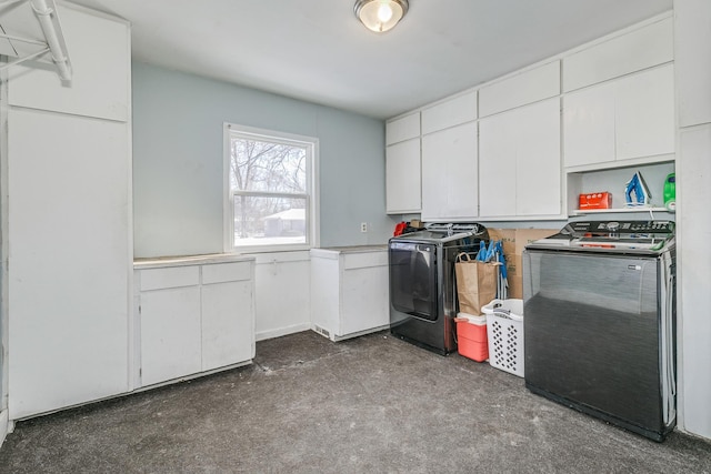 laundry area featuring washing machine and dryer and cabinet space