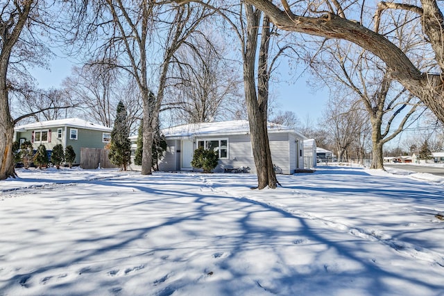 snow covered property featuring fence