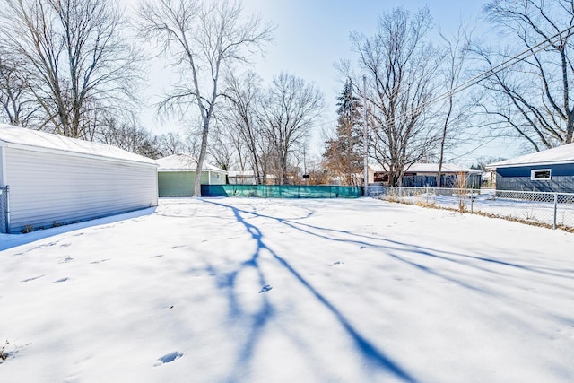 yard covered in snow with fence