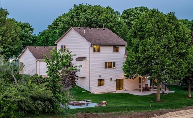19288 Evenston Dr, Farmington, MN 55024 - back of property featuring an outdoor fire pit, a patio, a lawn, and roof with shingles