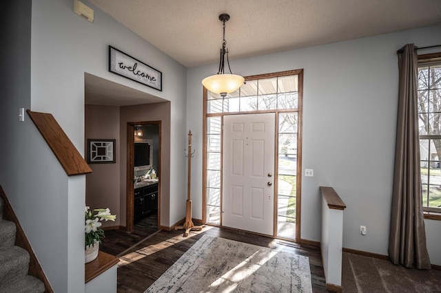 19288 Evenston Dr, Farmington, MN 55024 - foyer with dark wood finished floors, baseboards, stairway, and a textured ceiling