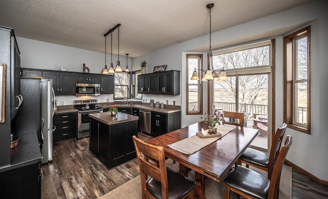 19288 Evenston Dr, Farmington, MN 55024 - dining area with a chandelier, dark wood-style floors, and a textured ceiling
