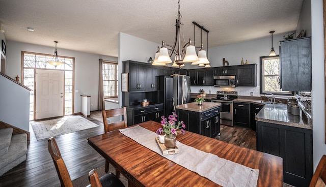 19288 Evenston Dr, Farmington, MN 55024 - dining area featuring dark wood-type flooring, stairway, and a textured ceiling
