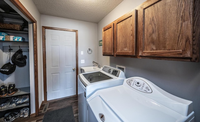 19288 Evenston Dr, Farmington, MN 55024 - laundry room with cabinet space, dark wood-style flooring, washer and clothes dryer, a textured ceiling, and baseboards