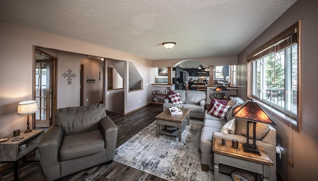 19288 Evenston Dr, Farmington, MN 55024 - living area featuring a textured ceiling, wood finished floors, arched walkways, and baseboards