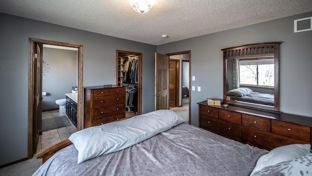 19288 Evenston Dr, Farmington, MN 55024 - bedroom with a textured ceiling, a spacious closet, connected bathroom, and a closet