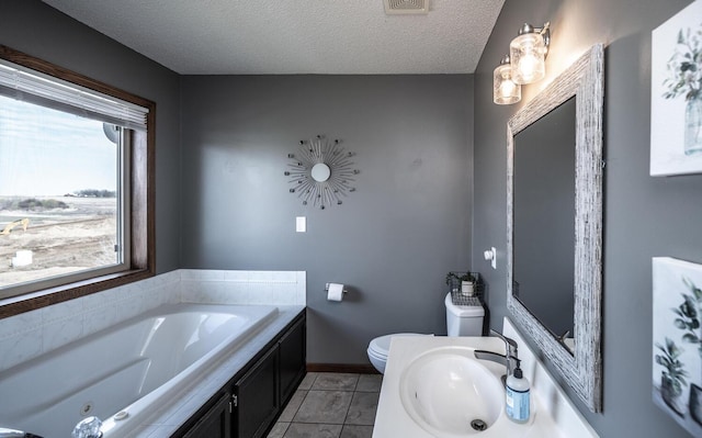 19288 Evenston Dr, Farmington, MN 55024 - full bathroom featuring a sink, toilet, a jetted tub, a textured ceiling, and tile patterned floors