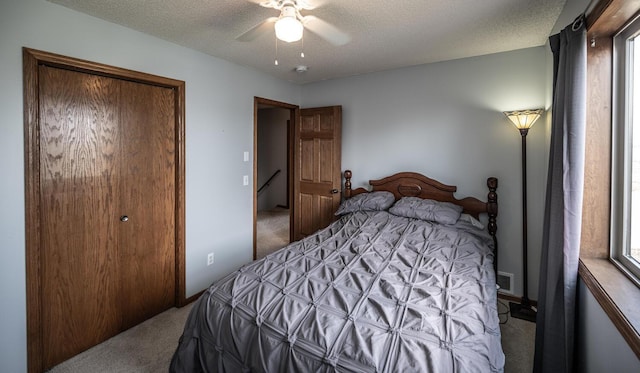 19288 Evenston Dr, Farmington, MN 55024 - bedroom with carpet floors, a textured ceiling, ceiling fan, and a closet