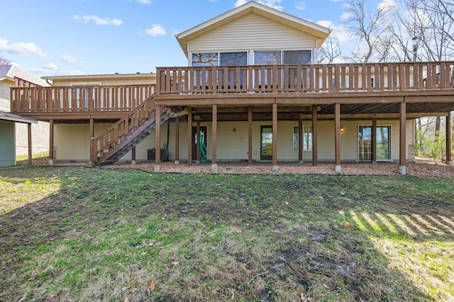 rear view of property featuring central AC, a lawn, a wooden deck, and stairway