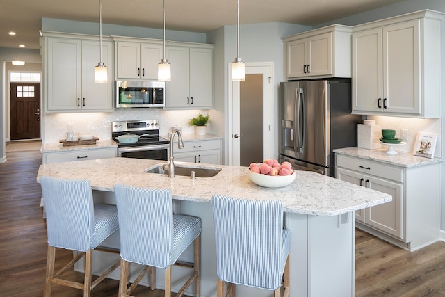 2717 Kalland Ave NE, Saint Michael, MN 55376 - kitchen with appliances with stainless steel finishes, a sink, tasteful backsplash, recessed lighting, and a kitchen bar