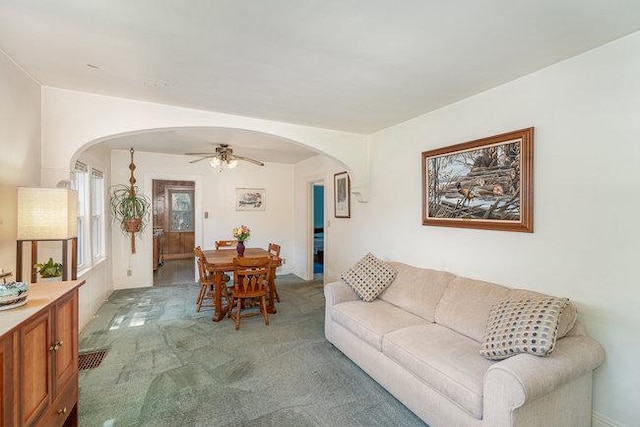 4528 30th Ave S, Minneapolis, MN 55406 - living area featuring arched walkways, a ceiling fan, and light colored carpet